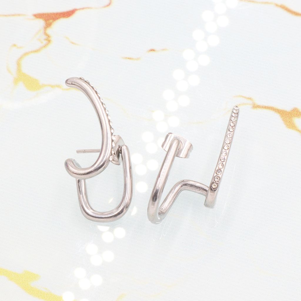 Ατσάλινα σκουλαρίκια Diplo σε ασημί χρώμα, διακοσμημένα με λευκά στρας. Ατσάλινα σκουλαρίκια Diplo σε ασημί χρώμα, διακοσμημένα με λευκά στρας.